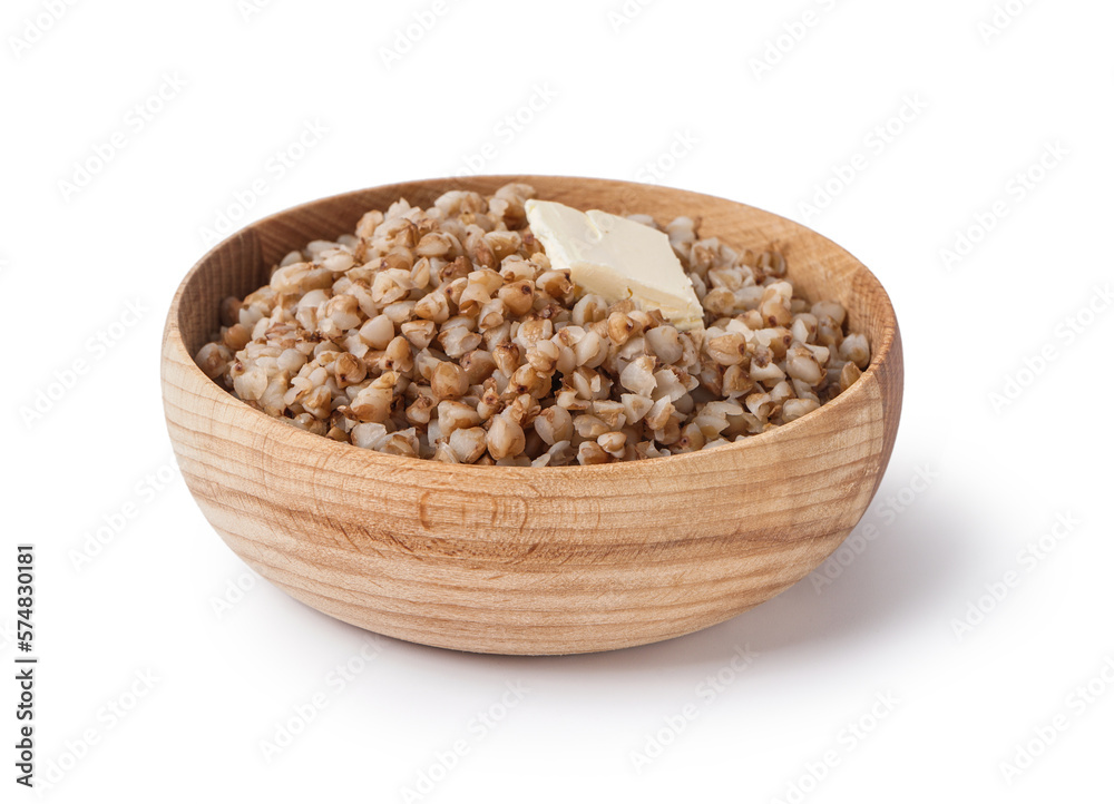 Wooden bowl of tasty buckwheat porridge with butter isolated on white background