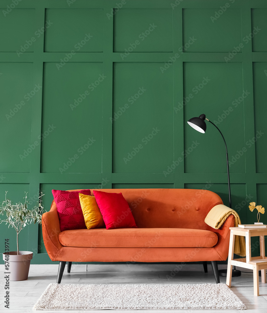 Interior of stylish living room with red sofa, stepladder and lamp