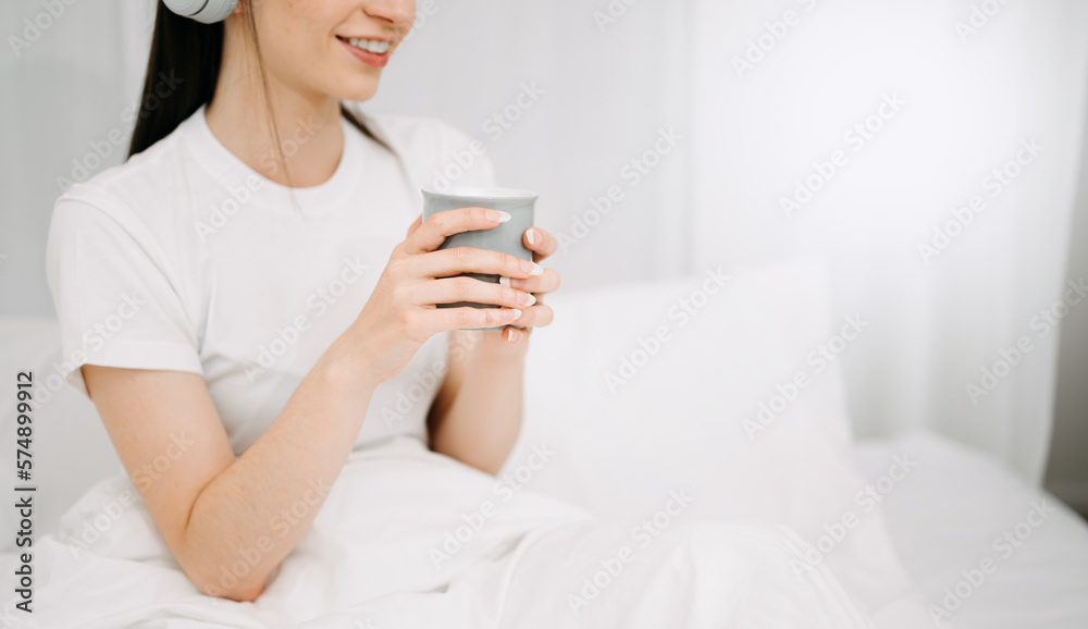 Good Healthy woman drinking tea and resting in white bed at bedroom. Lifestyle at home concept in mo