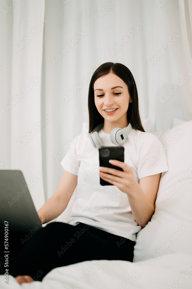 Beautiful woman has woken up on a white bed and holding coffee in the morning at home in morning