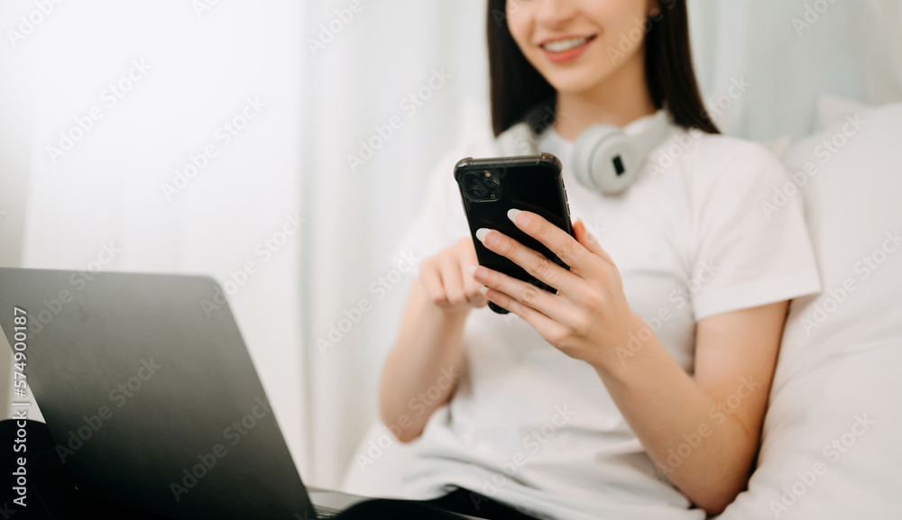 Beautiful woman has woken up on a white bed and holding coffee in the morning at home in morning