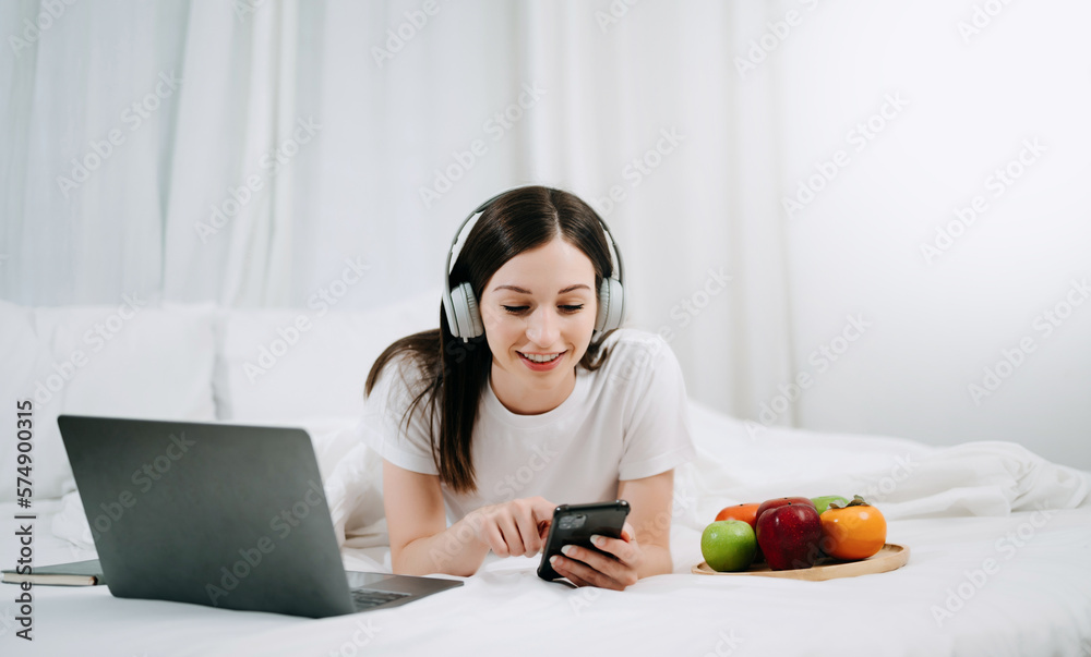 Beautiful woman resting and watching movie in bed at bedroom in morning Lifestyle at home