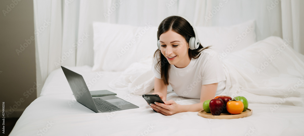 Beautiful woman resting and watching movie in bed at bedroom in morning Lifestyle at home