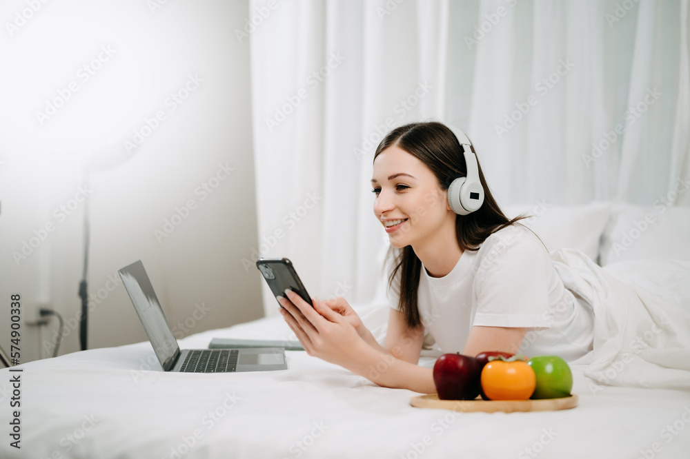 Beautiful woman resting and watching movie in bed at bedroom in morning Lifestyle at home