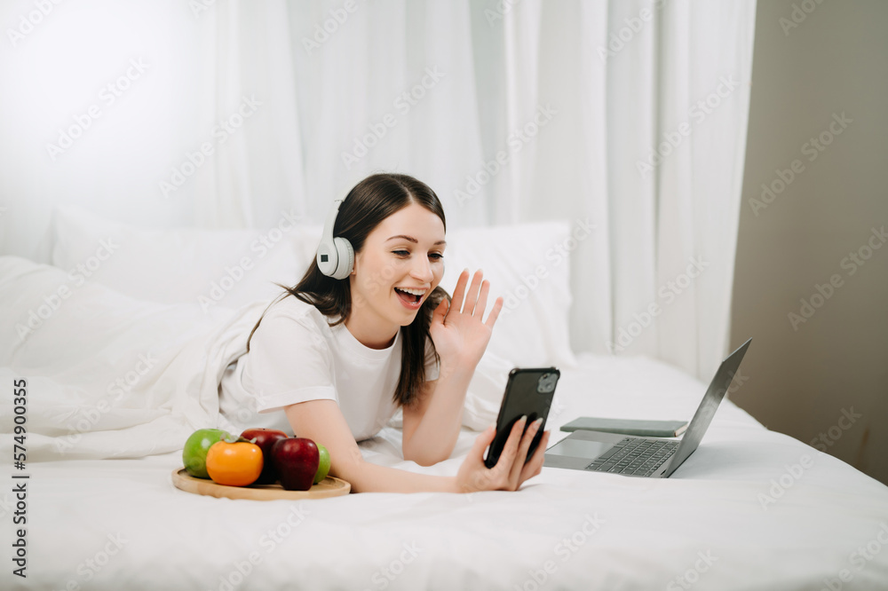 Beautiful woman resting and watching movie in bed at bedroom in morning Lifestyle at home