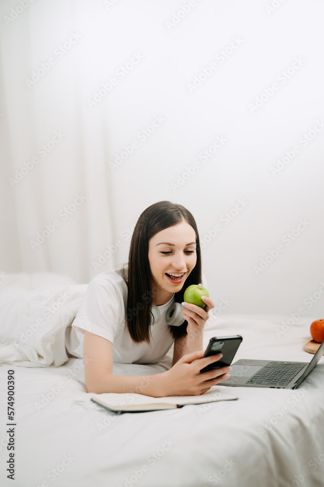 Beautiful woman resting and watching movie in bed at bedroom in morning Lifestyle at home