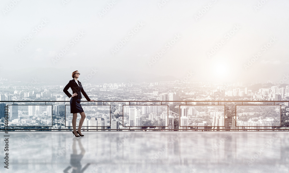 Sunrise above skyscrapers and businesswoman facing new day