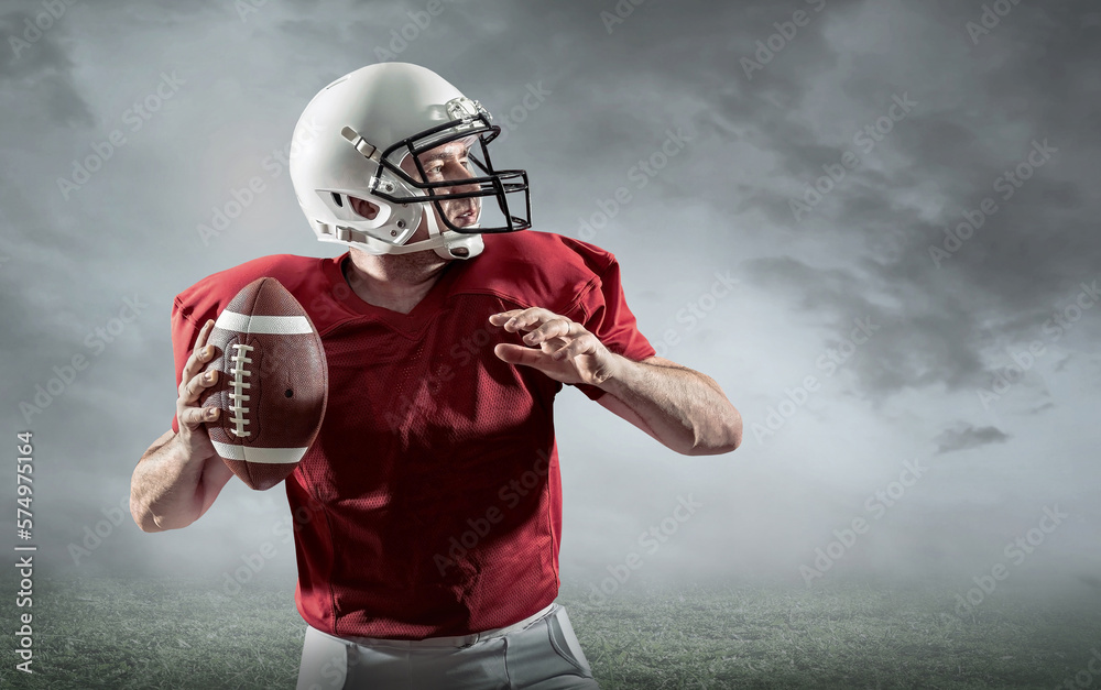 American football sportsman player with ball in action on stadium under lights of background. Sport,