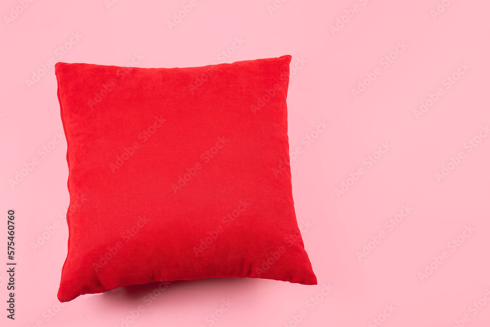 Red pillow on pink background