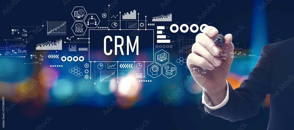 CRM - Customer Relationship Management theme with businessman in a city at night