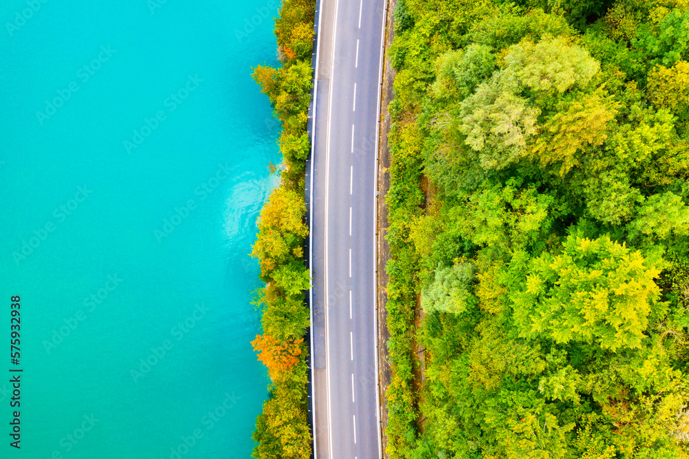 The road near turquoise lake. Aerial landscape. The road by the lake in Switzerland. Summer landscap