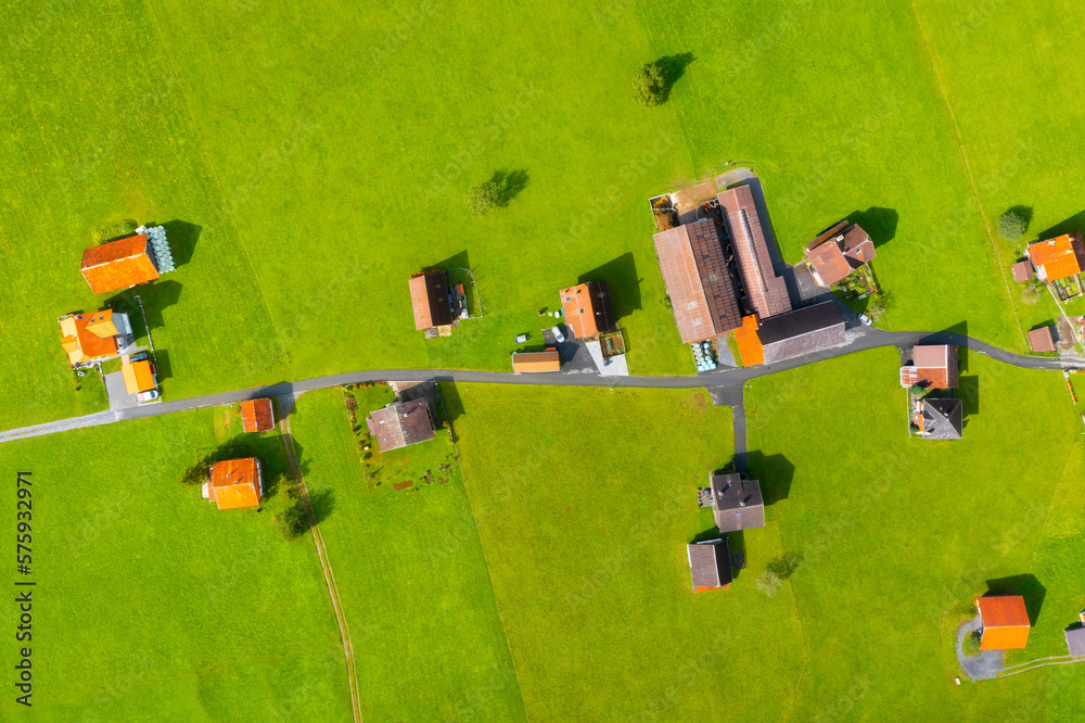 Aerial view of the village and the streets. View of the countryside from a drone. Roofs of houses wi