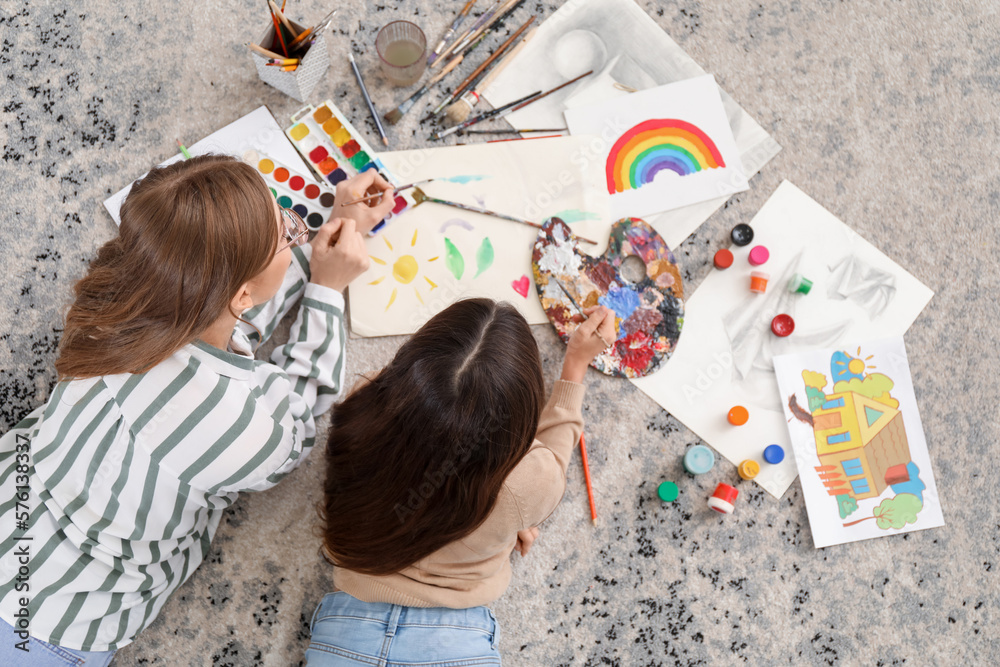 Drawing teacher giving private art lesson to little girl at home, top view