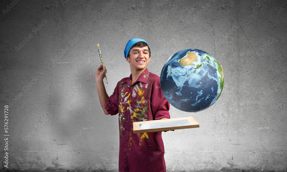 Young artist holding earth globe on hand.