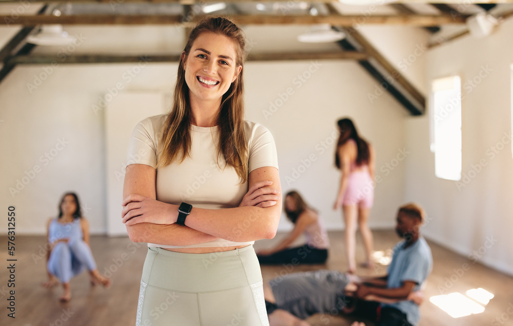 Female fitness instructor standing in a yoga class