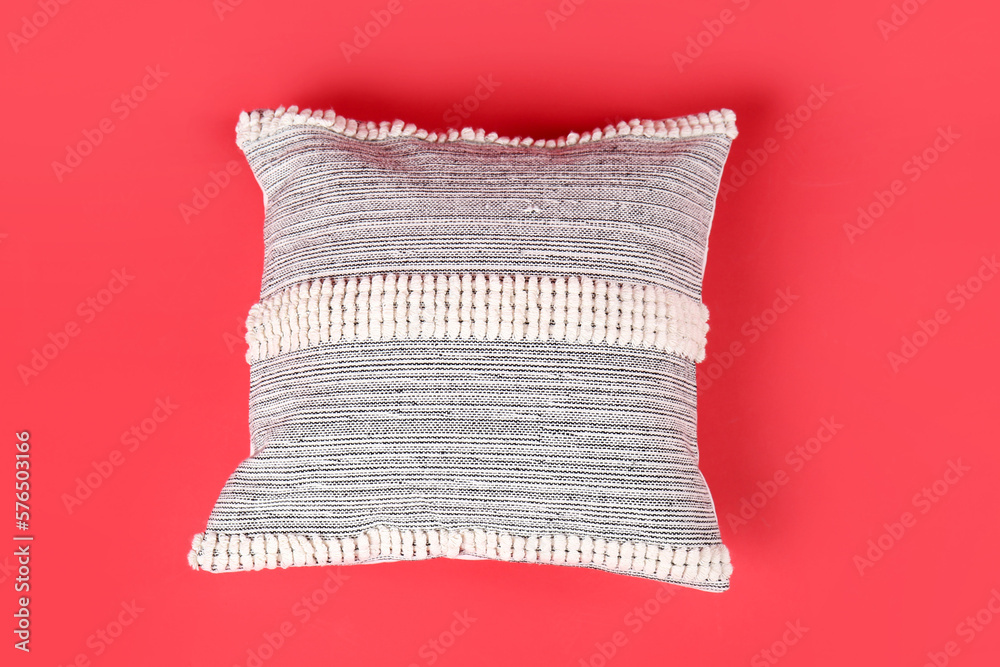 Decorative pillow on red background