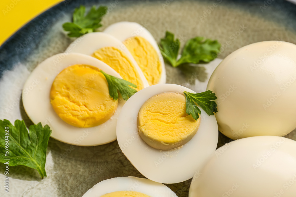 Delicious boiled eggs with parsley on plate, closeup