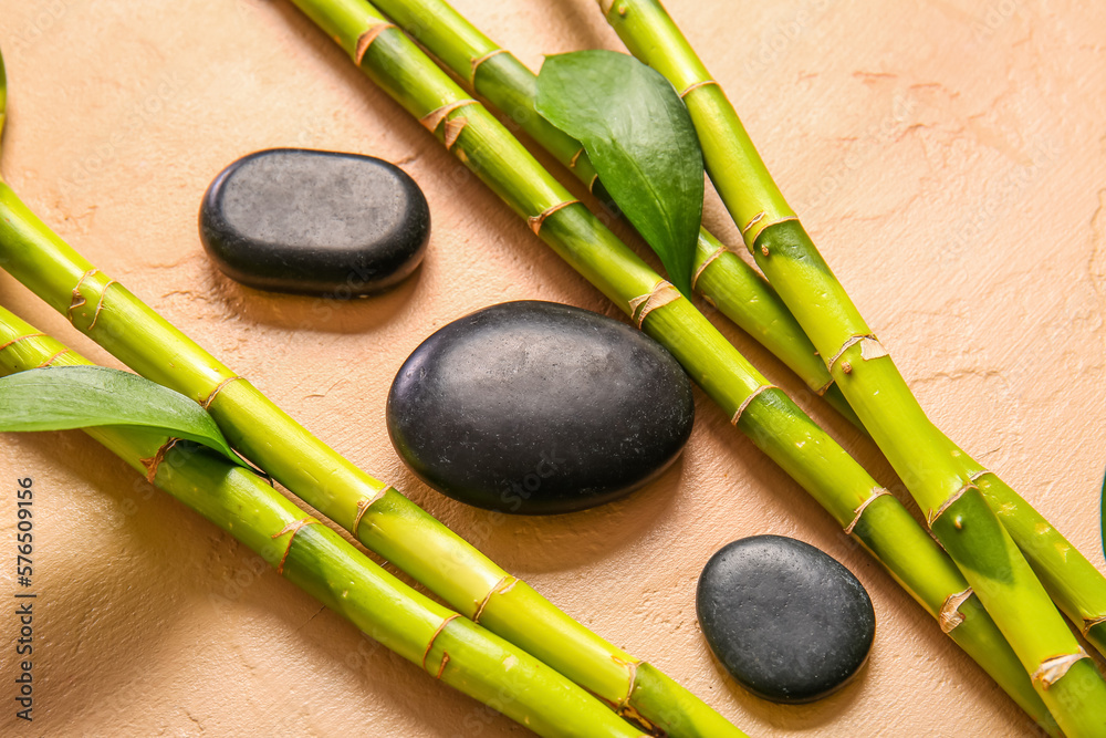 Spa stones and bamboo on beige background