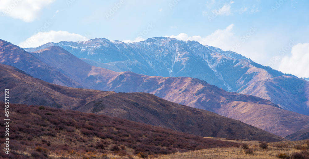 Amazing mountain landscape with cloudy sky. Panorama of beautiful countryside. Wonderful autumn in m