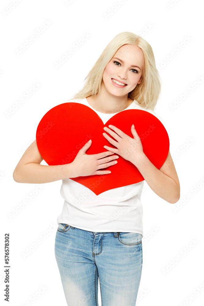 A young blonde girlfriend with a smiling face cuddles a red heart-shaped paper board and shows love,