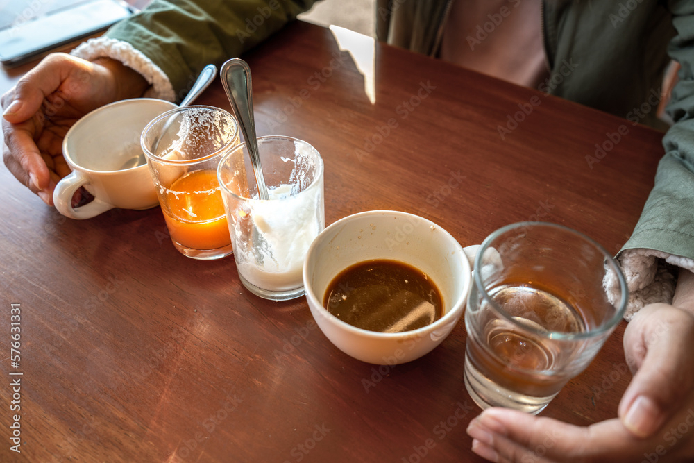 Scrap of food in the white Cup after Drink. Different cups of coffee on wooden table, top view