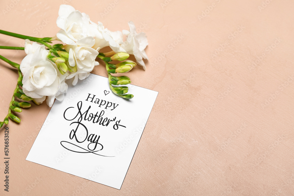 Greeting card with text HAPPY MOTHERS DAY and beautiful freesia flowers on color background