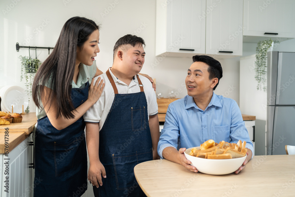 Asian happy family, mature parents baking bakery with son in kitchen. 