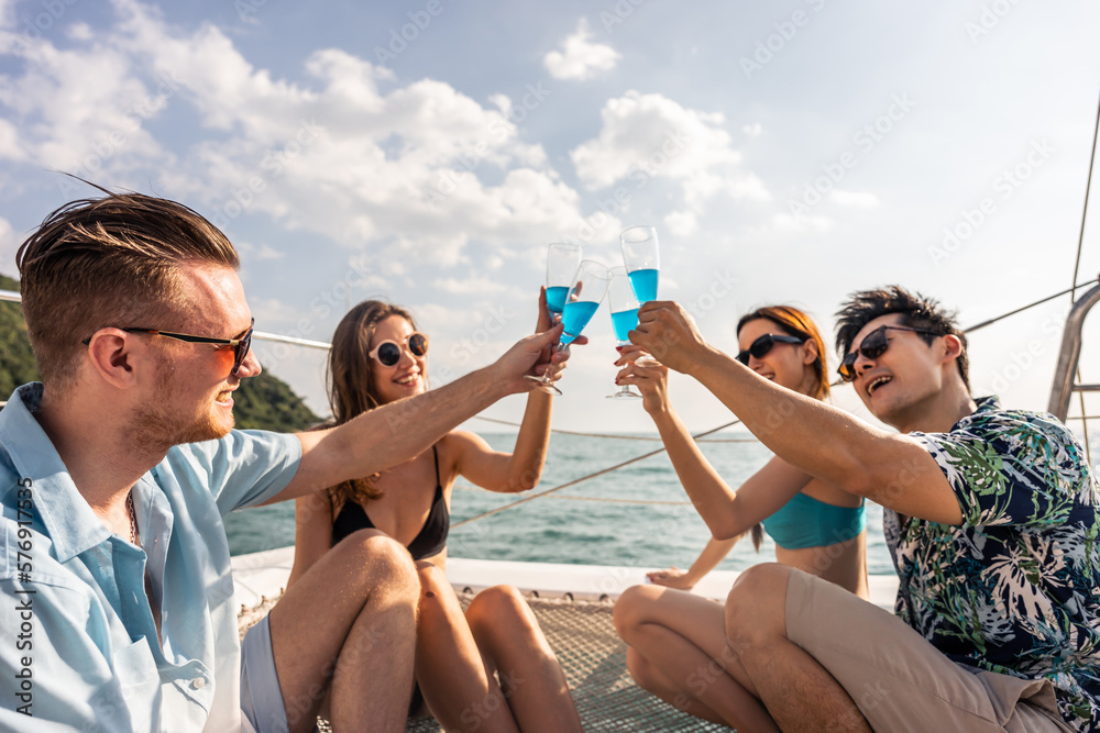 Group of diverse friends drink champagne while having a party in yacht. 