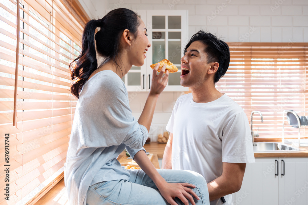 Asian young new marriage couple spend time together in kitchen at home. 