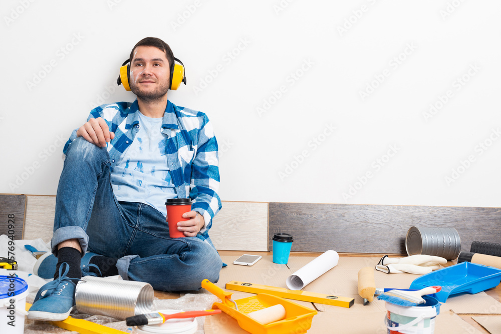 Happy boy in protective headphones sitting