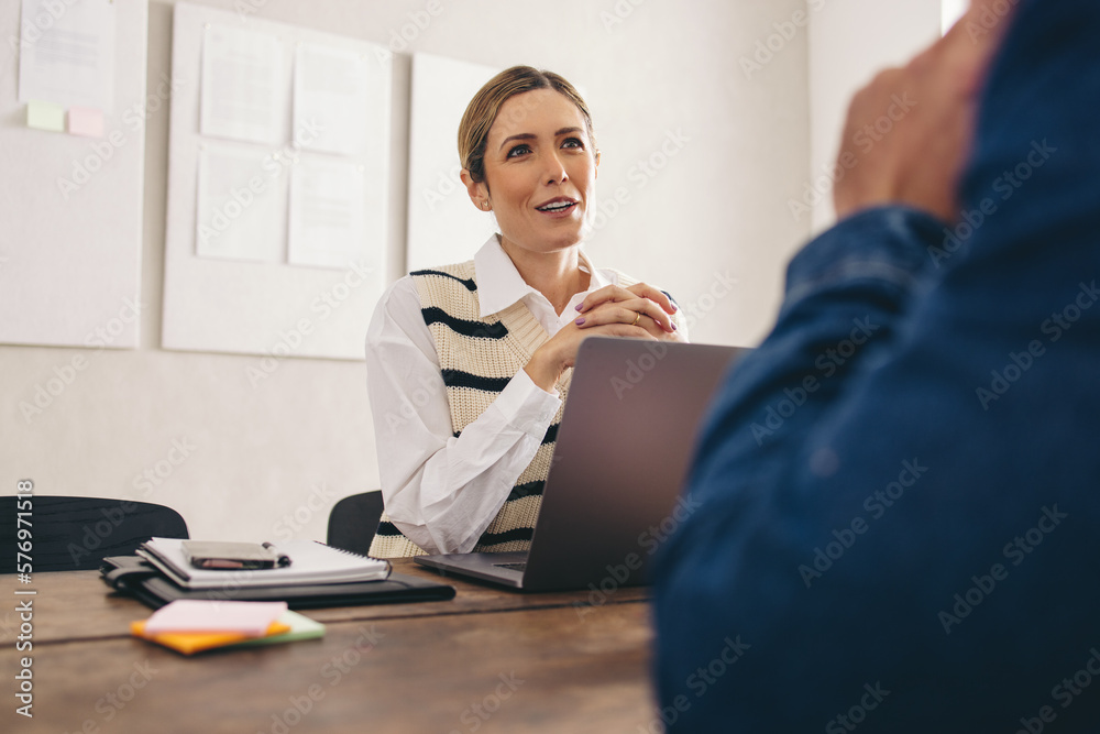 Businesswoman negotiating with a business partner in her office