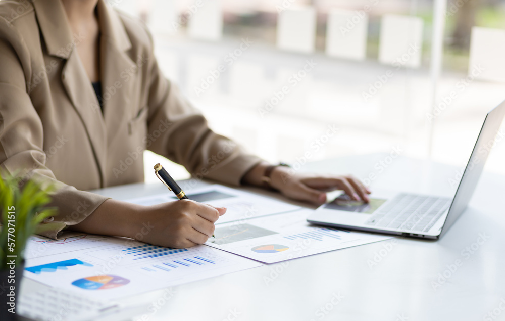 Businesswoman working with financial accounting documents in the office.