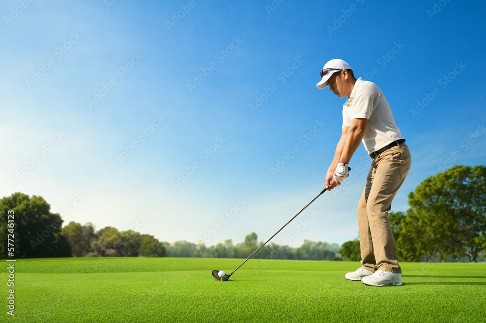 Golfer ready tee-off with drivers on golf teeing ground.