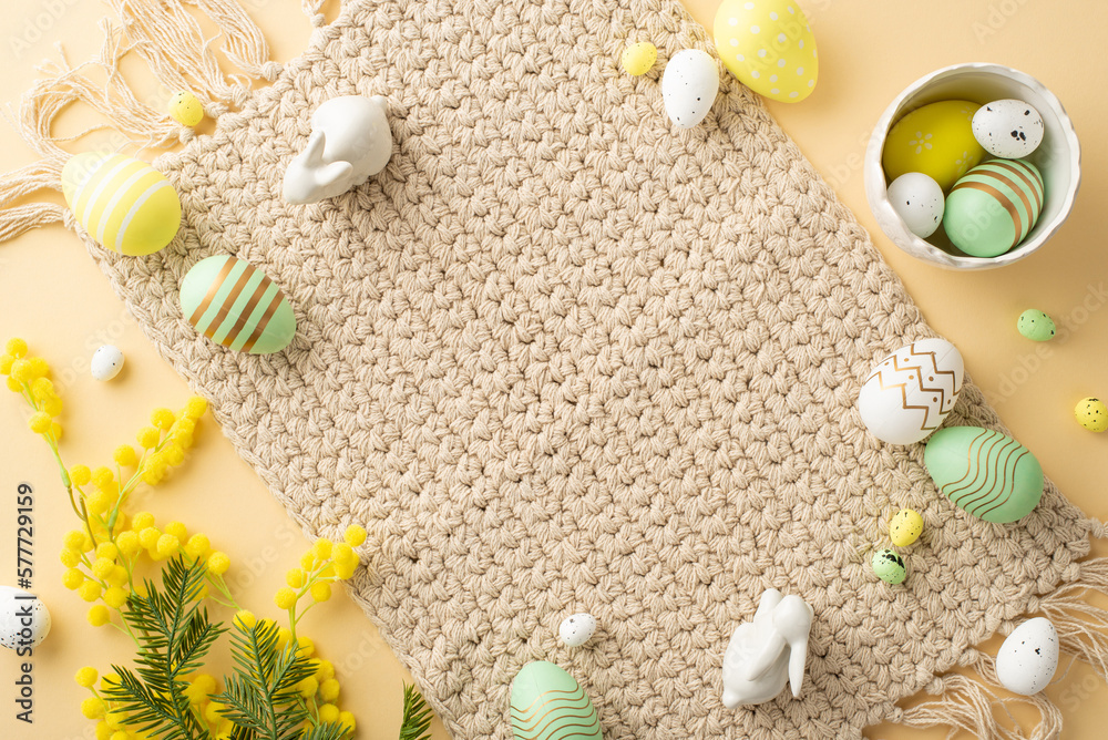 Easter celebration concept. Top view photo of bowl with colorful easter eggs ceramic bunnies cloth n