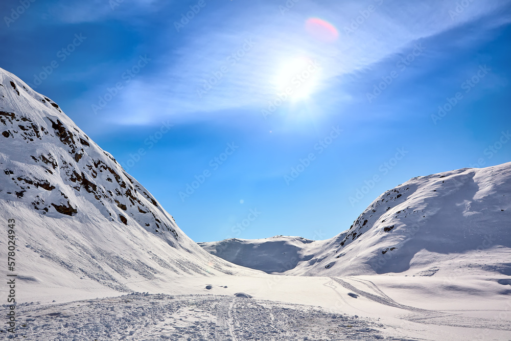 Arctic landscape of East Greenland with mountains and sun