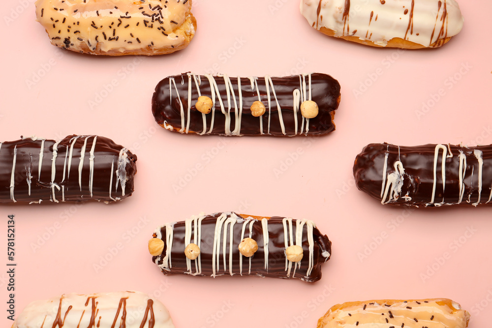 Many delicious eclairs on pink background