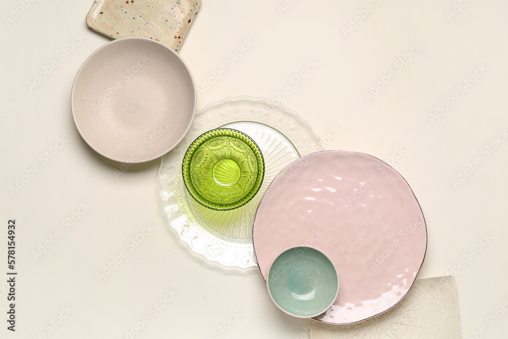 Composition with clean ceramic plates and bowls on white background