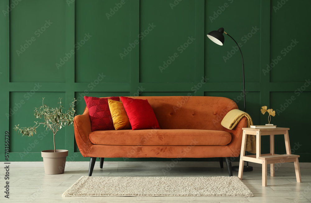 Interior of stylish living room with red sofa, stepladder and lamp