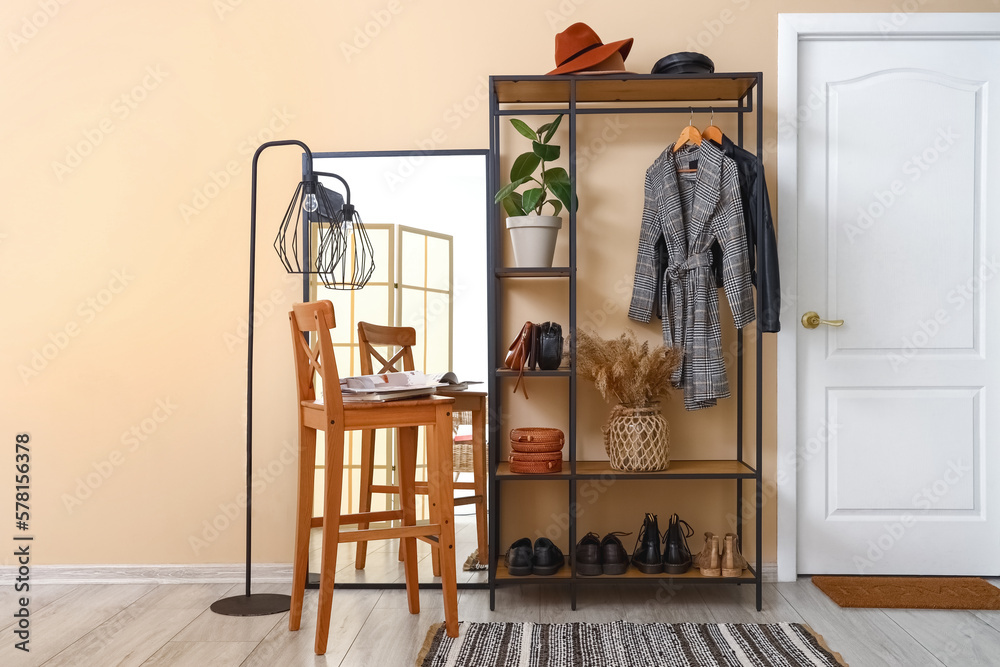 Interior of hall with shelving unit, stool and mirror