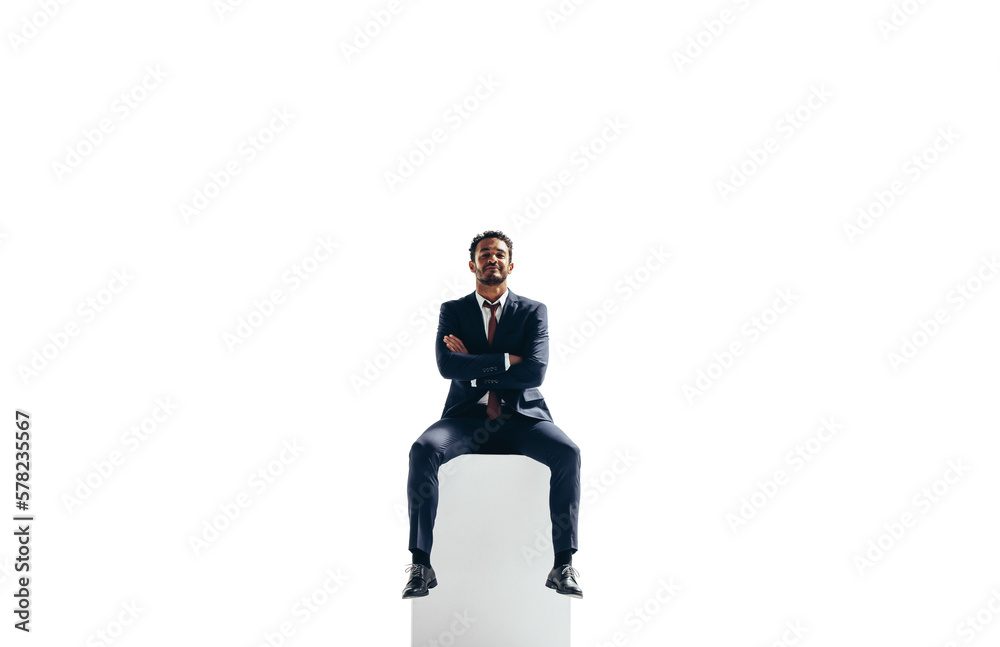 Confident young businessman sitting on top of a block on a transparent background