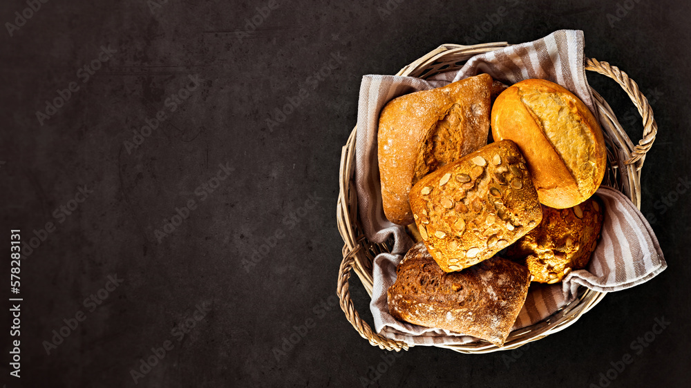 Basket with appetizing rolls on a black background. View from above