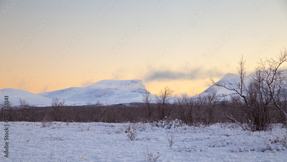 The mountain ‘Lapporten Gate’ with the yellow sky at sunset 