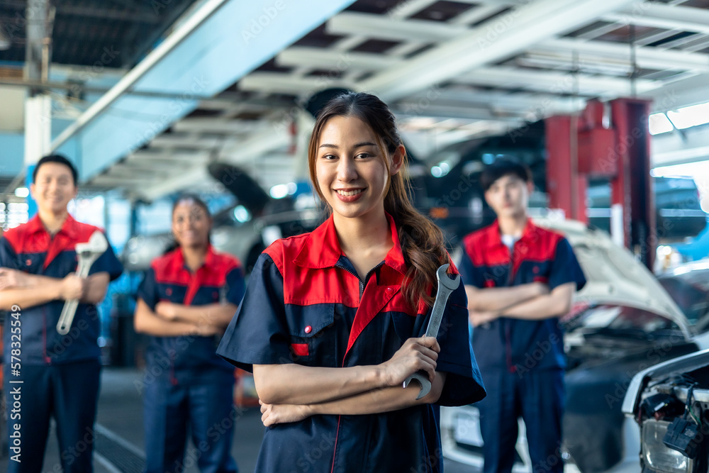 Asian and African  automotive engineer people wear helmet work in mechanics garage.young auto mechan