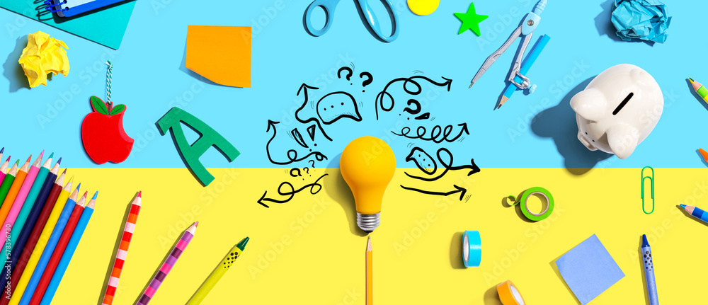 Brainstorming concept with a light bulb and school supplies - Flat lay