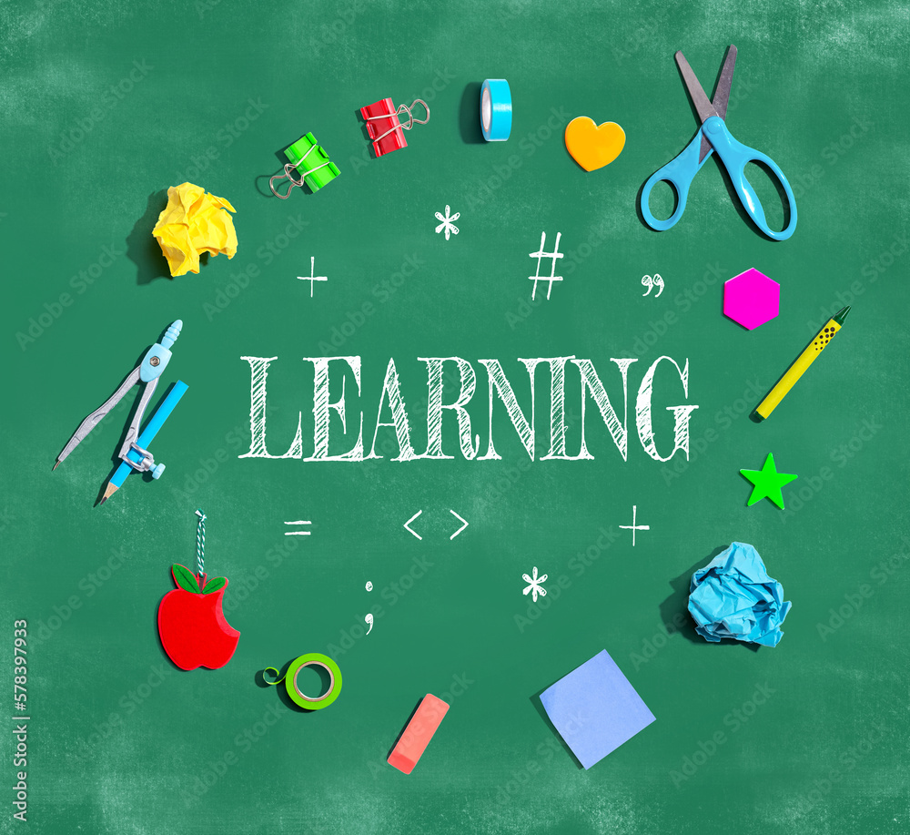 Learning concept with school supplies on a chalkboard - flat lay