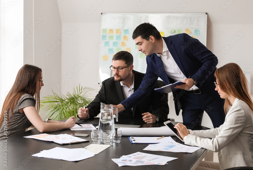 Group of people working on business plan in office