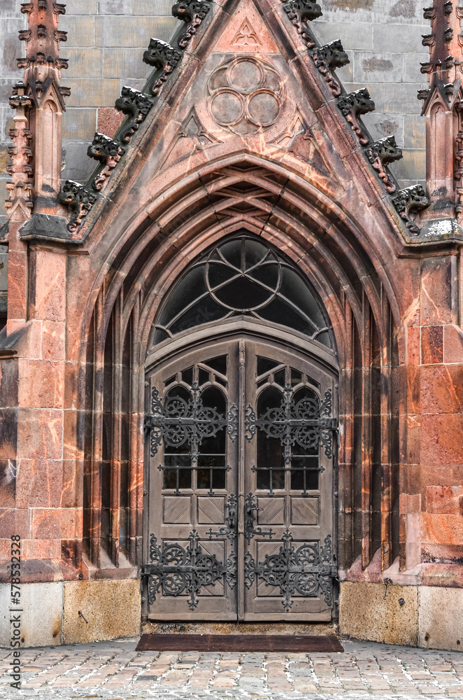 View of old Gothic building with beautiful door