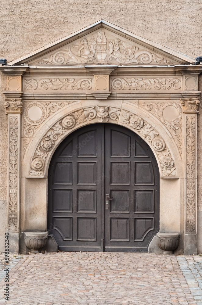 View of old building with dark wooden door