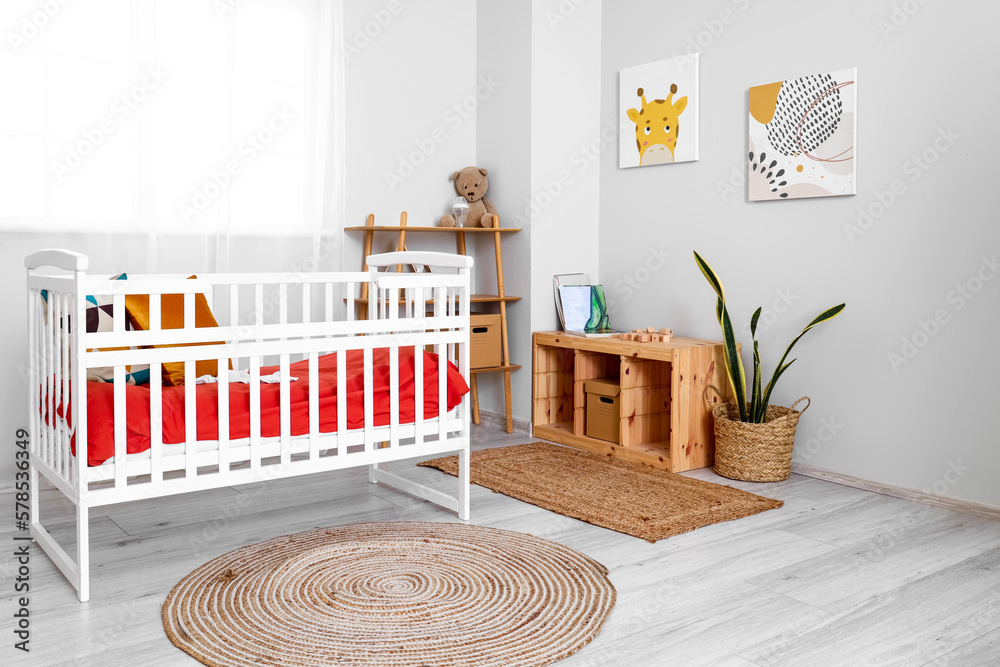 Interior of childrens bedroom with crib and shelving unit