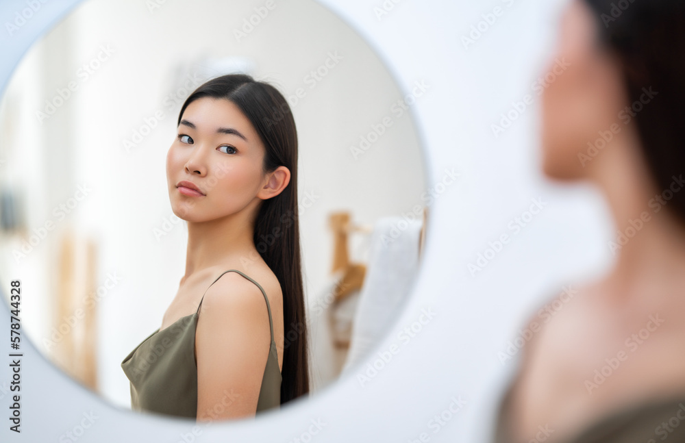 woman looking at mirror